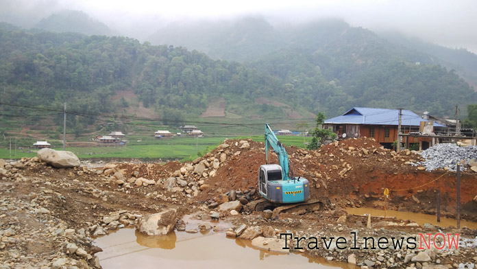 Backhoe machine at work in a dry river at Xa Ho, Tram Tau